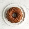 imageNordic Ware Formed Orginal Bundt with Translucent Keeper 12 Cup Golden HourTwilight Blue